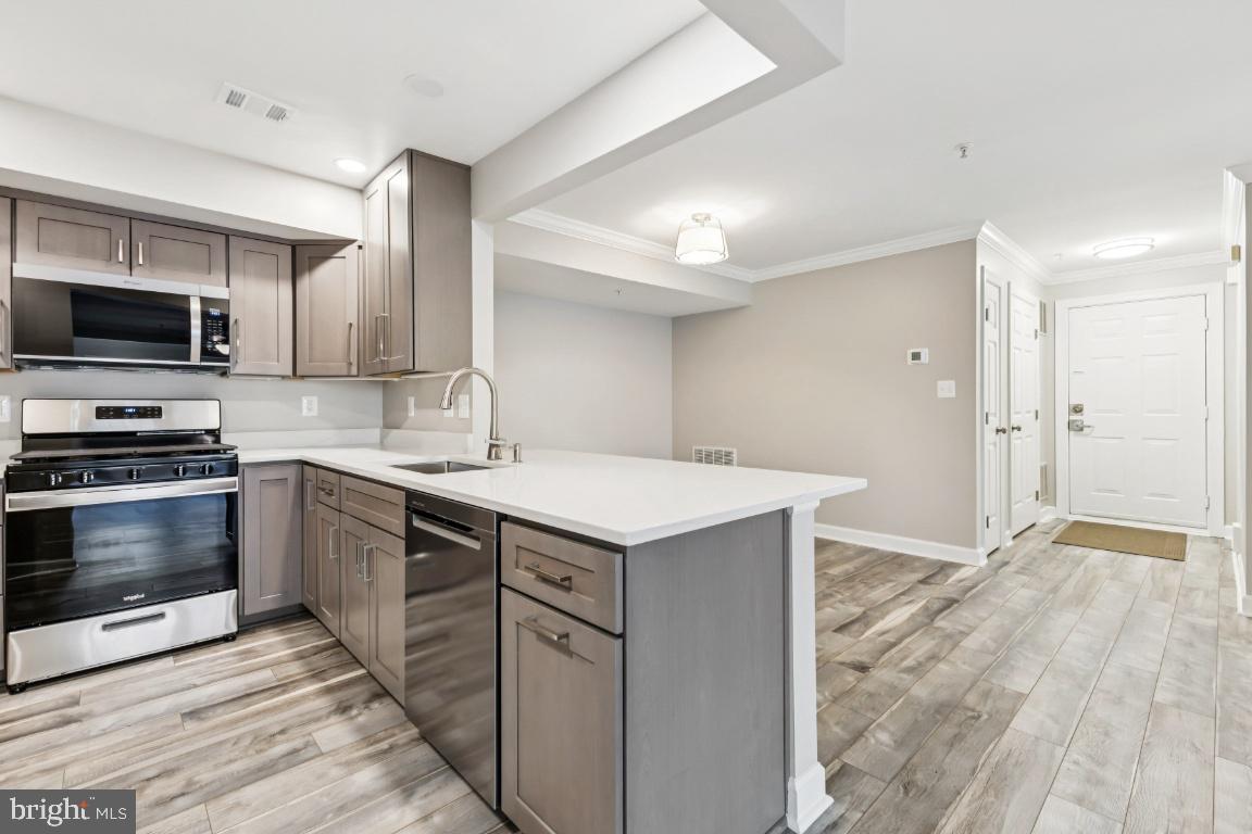 8311 A Bluebird Way, Unit A Lorton, VA 22079 - Photo 11 of 25 a kitchen with a stove and a microwave