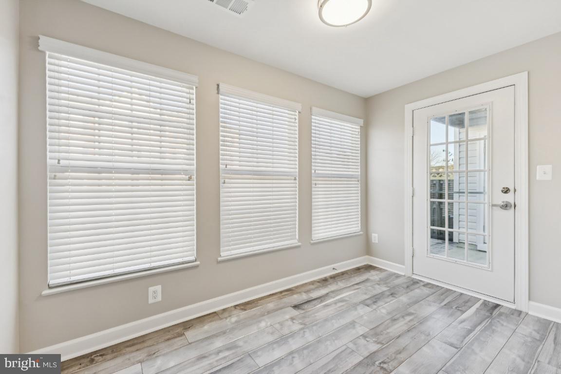 8311 A Bluebird Way, Unit A Lorton, VA 22079 - Photo 13 of 25 an empty room with wooden floor and windows
