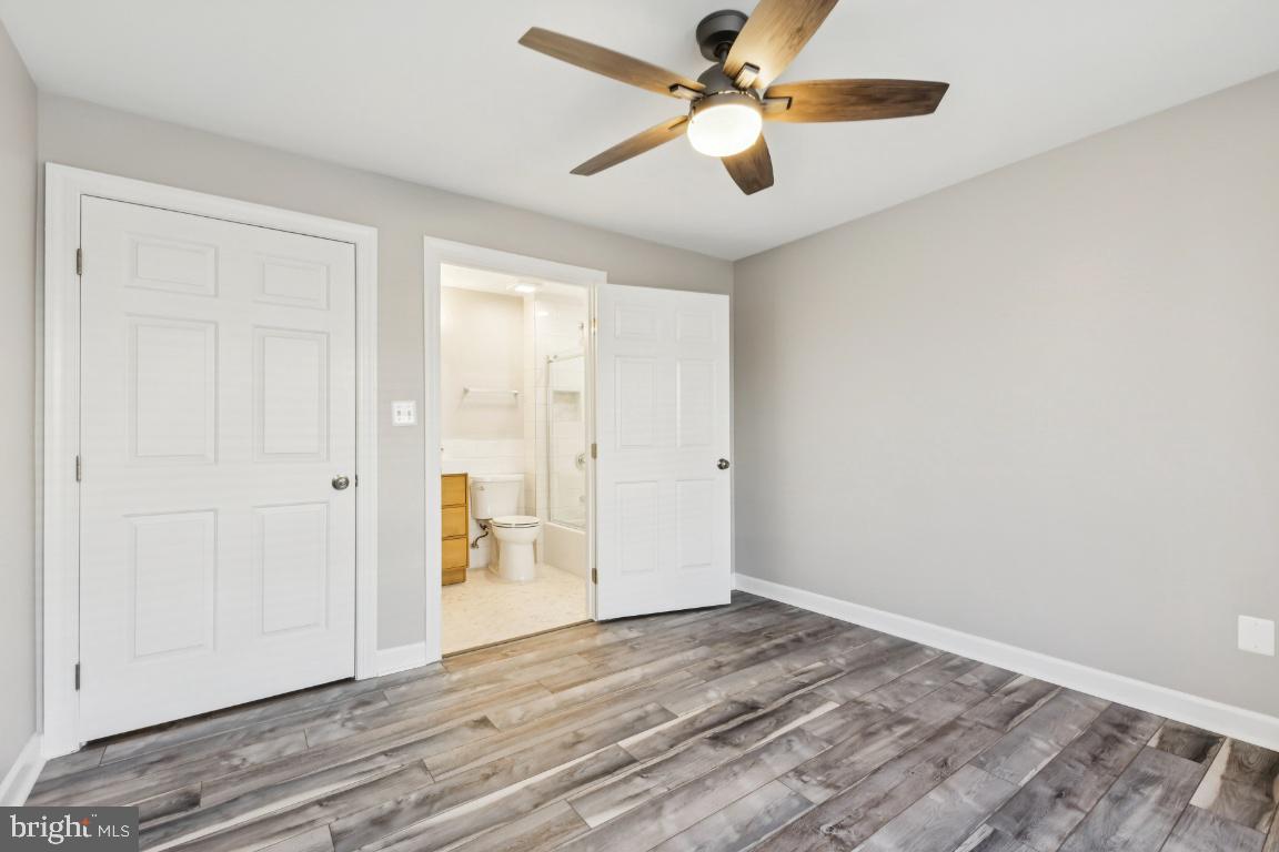 8311 A Bluebird Way, Unit A Lorton, VA 22079 - Photo 18 of 25 an empty room with wooden floor a ceiling fan and closet
