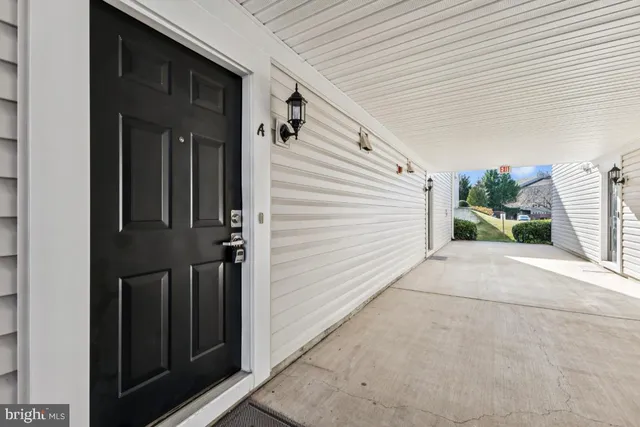 a view of a porch with a door and wooden walls