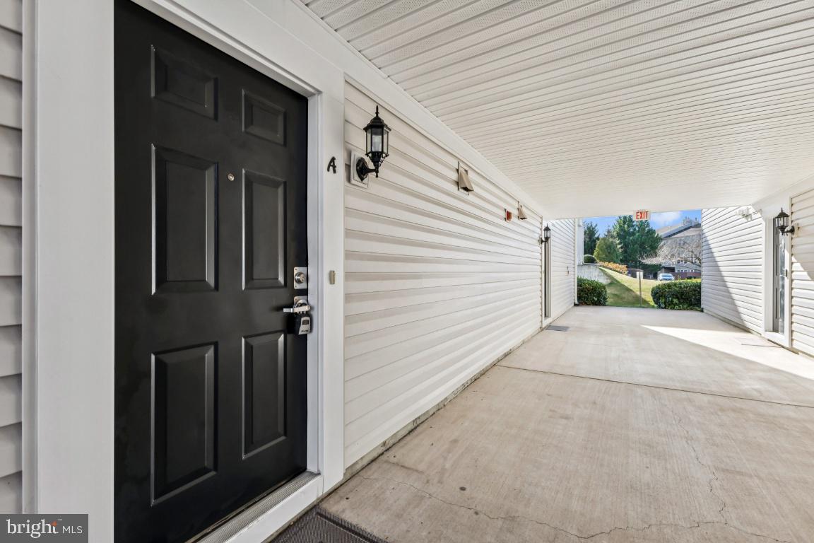 8311 A Bluebird Way, Unit A Lorton, VA 22079 - Photo 2 of 25 a view of a porch with a door and wooden walls