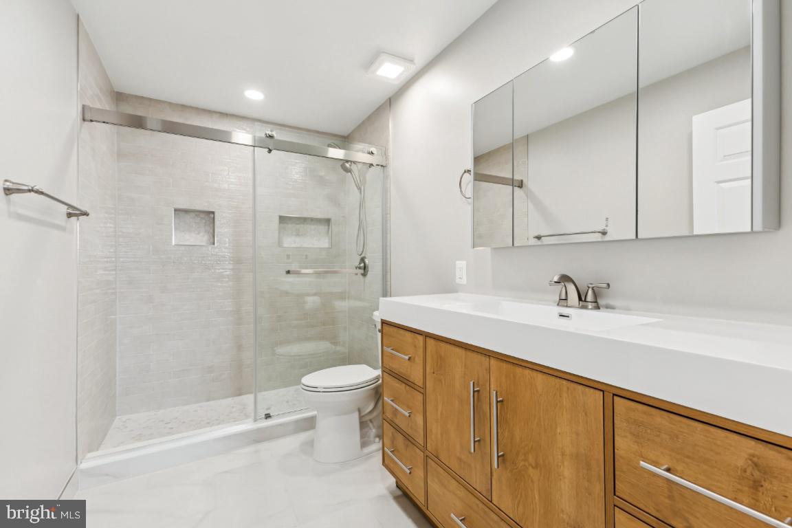 8311 A Bluebird Way, Unit A Lorton, VA 22079 - Photo 23 of 25 a bathroom with a sink a toilet and shower