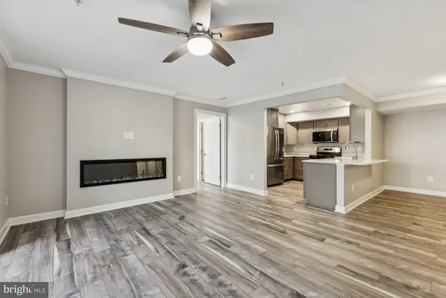 a view of kitchen and hall with wooden floor