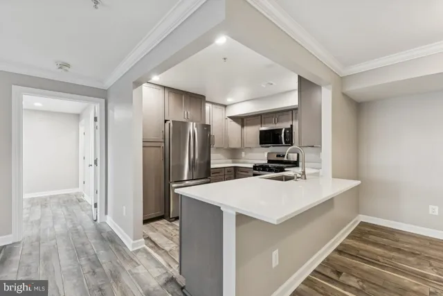 a kitchen with a refrigerator microwave and stove