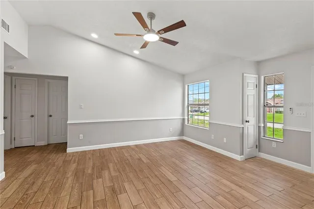wooden floor in an empty room with a window