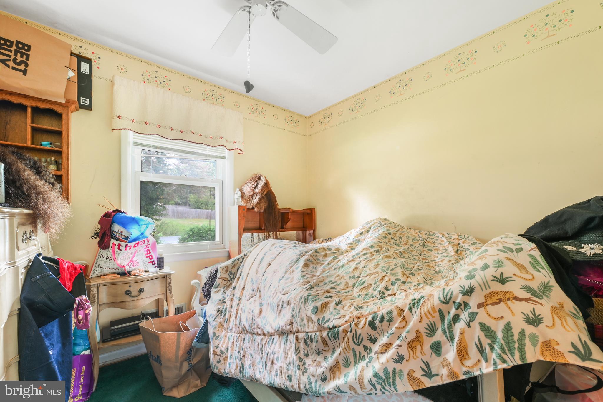 6102 Shady Spring Avenue Baltimore, MD 21237 - Photo 14 of 26 a bed room with a bed and a chair