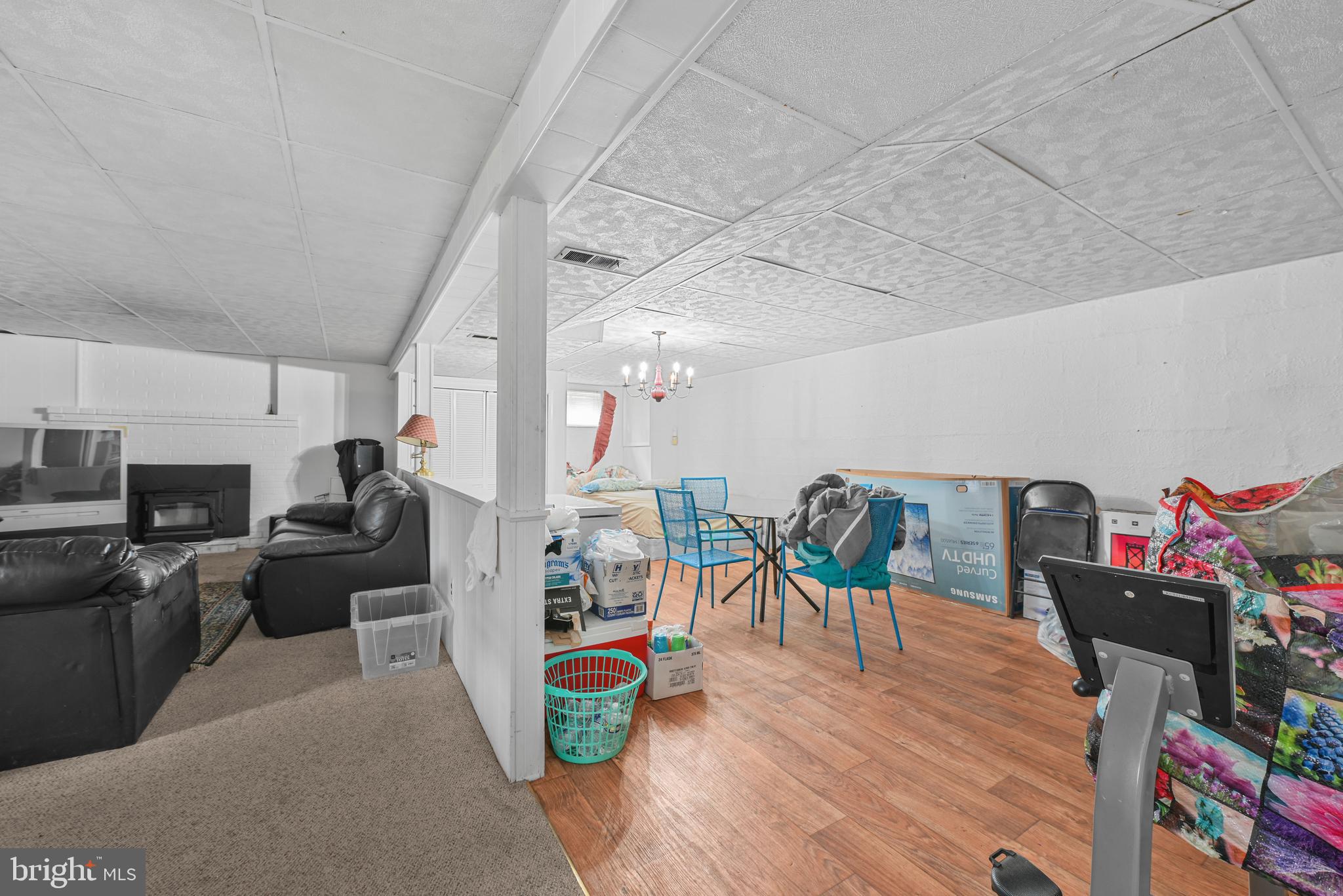 6102 Shady Spring Avenue Baltimore, MD 21237 - Photo 18 of 26 a living room with furniture a flat screen tv and a table