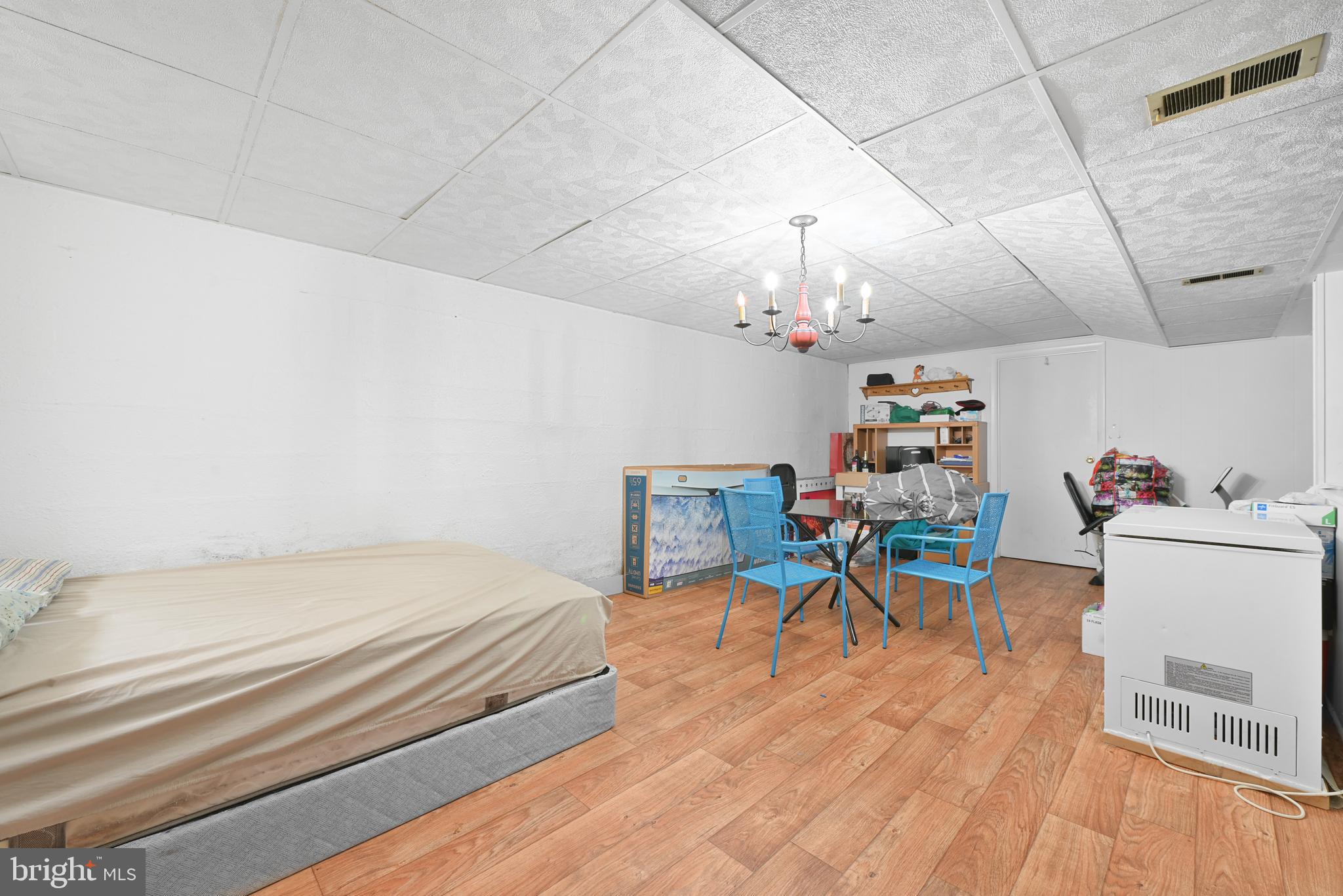 6102 Shady Spring Avenue Baltimore, MD 21237 - Photo 20 of 26 a bedroom with a bed and a table chair