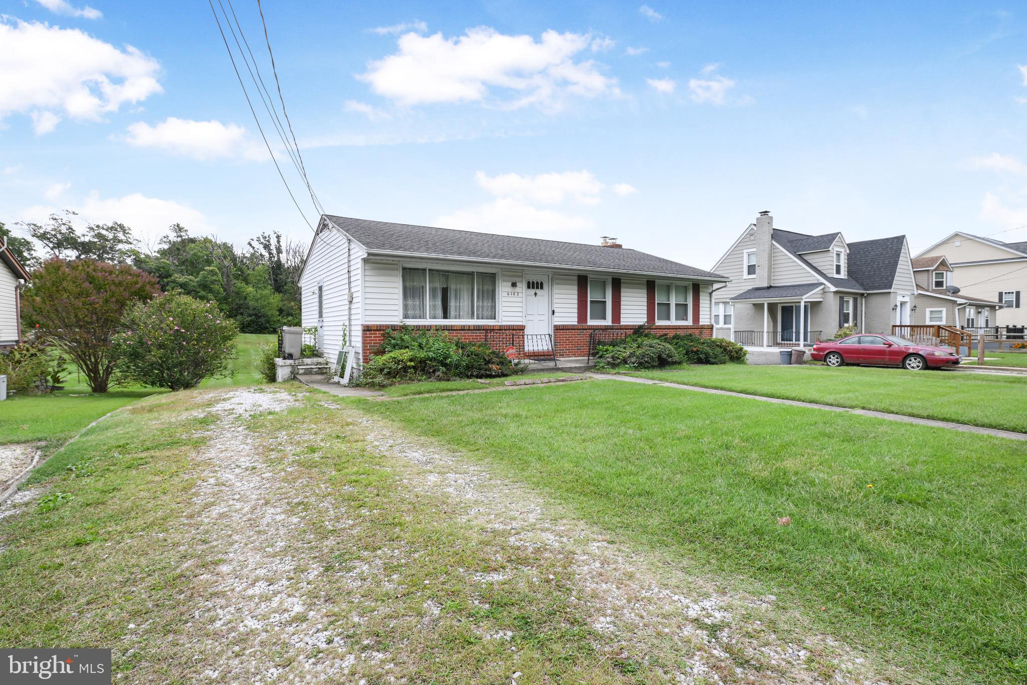 6102 Shady Spring Avenue Baltimore, MD 21237 - Photo 2 of 26 a front view of house with yard and green space