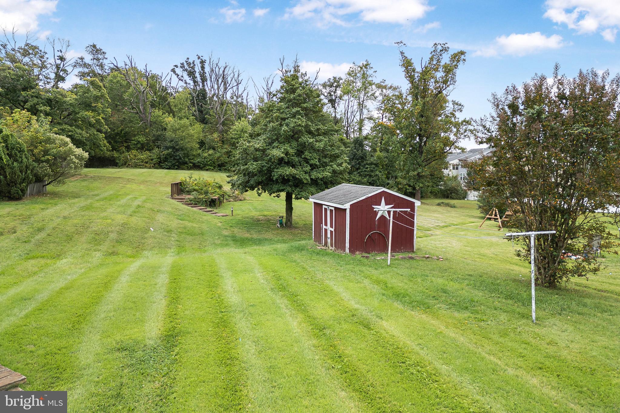 6102 Shady Spring Avenue Baltimore, MD 21237 - Photo 23 of 26 a view of a big yard with large trees and plants