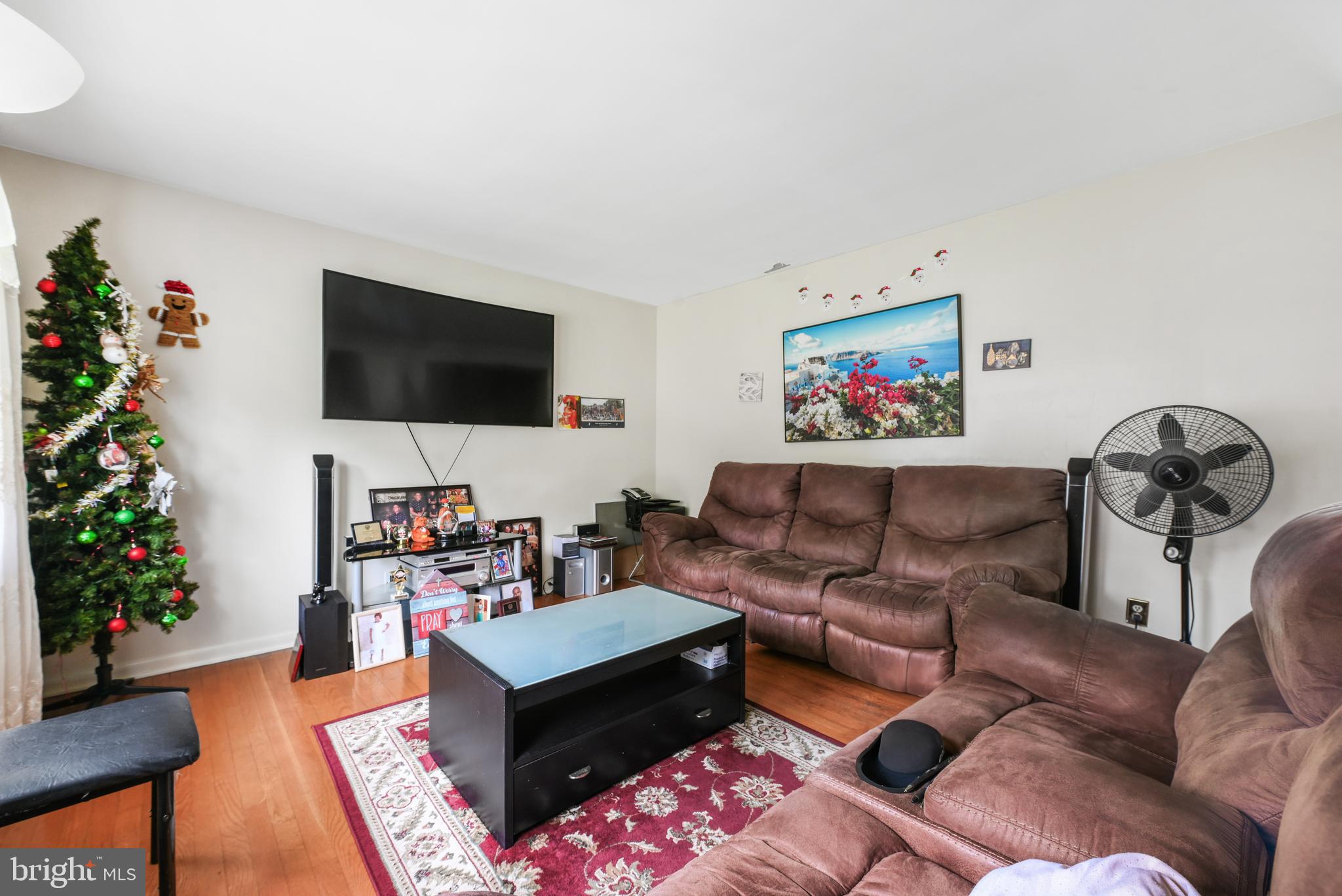6102 Shady Spring Avenue Baltimore, MD 21237 - Photo 4 of 26 a living room with furniture and a flat screen tv