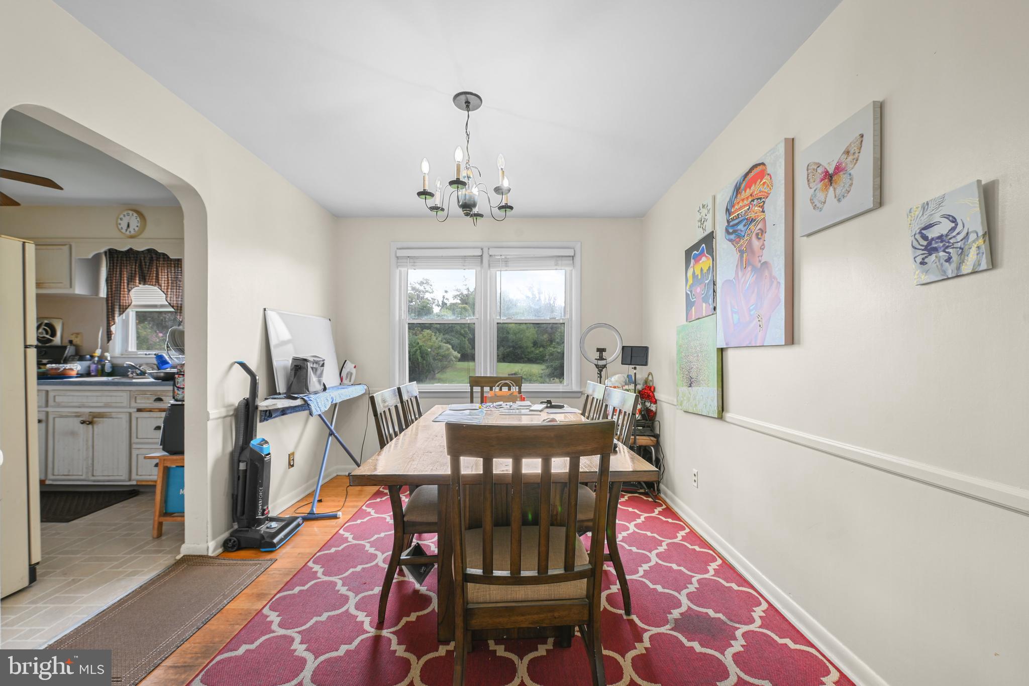 6102 Shady Spring Avenue Baltimore, MD 21237 - Photo 7 of 26 a living room with furniture and a chandelier