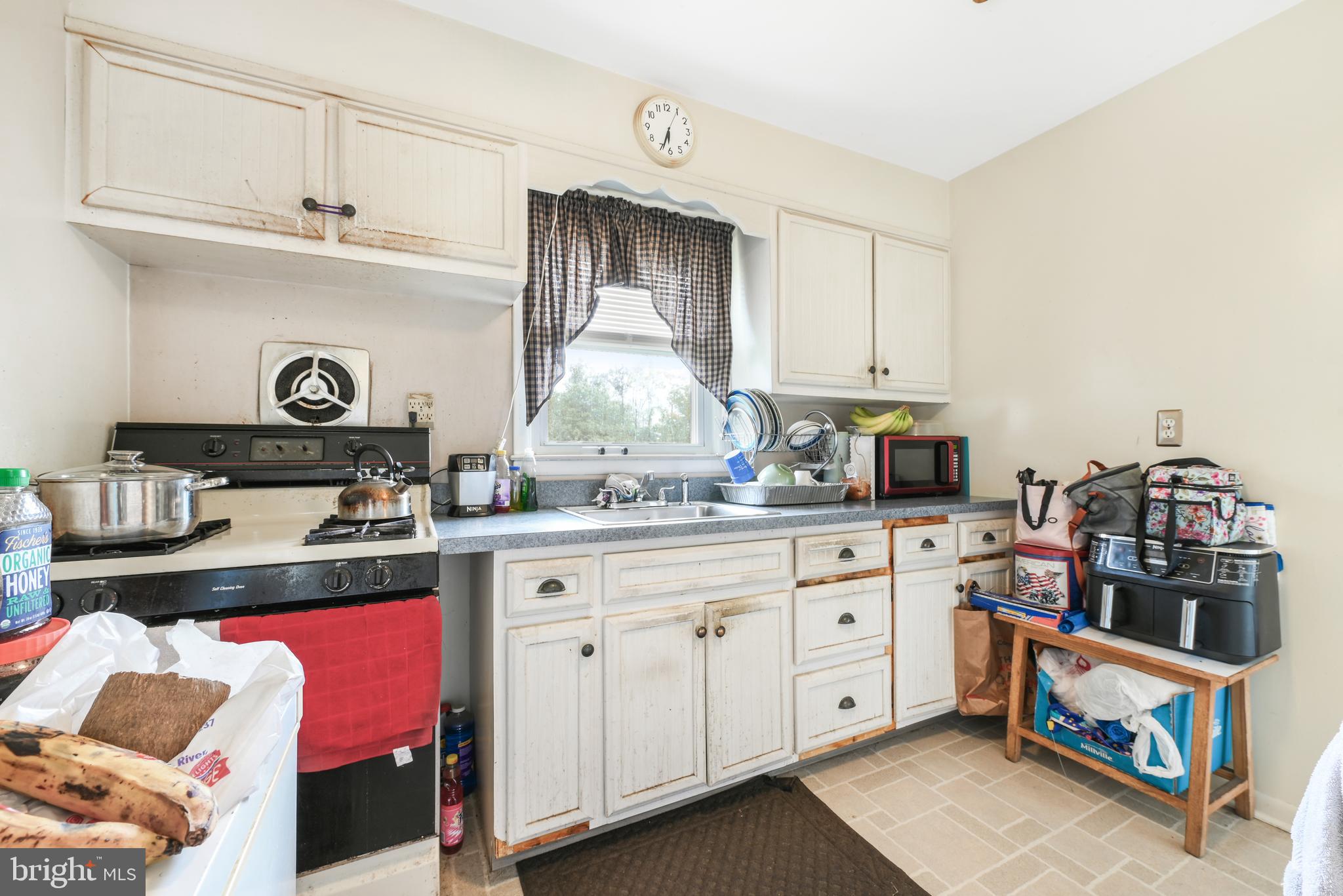 6102 Shady Spring Avenue Baltimore, MD 21237 - Photo 10 of 26 a kitchen with cabinets and appliances