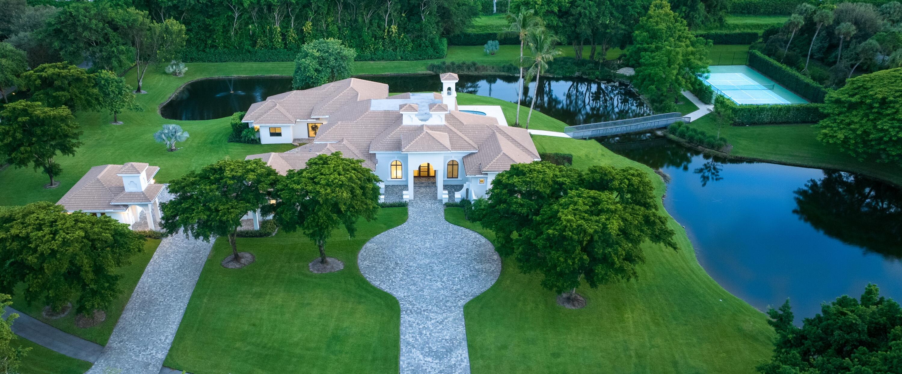 an aerial view of a house with garden space and lake view