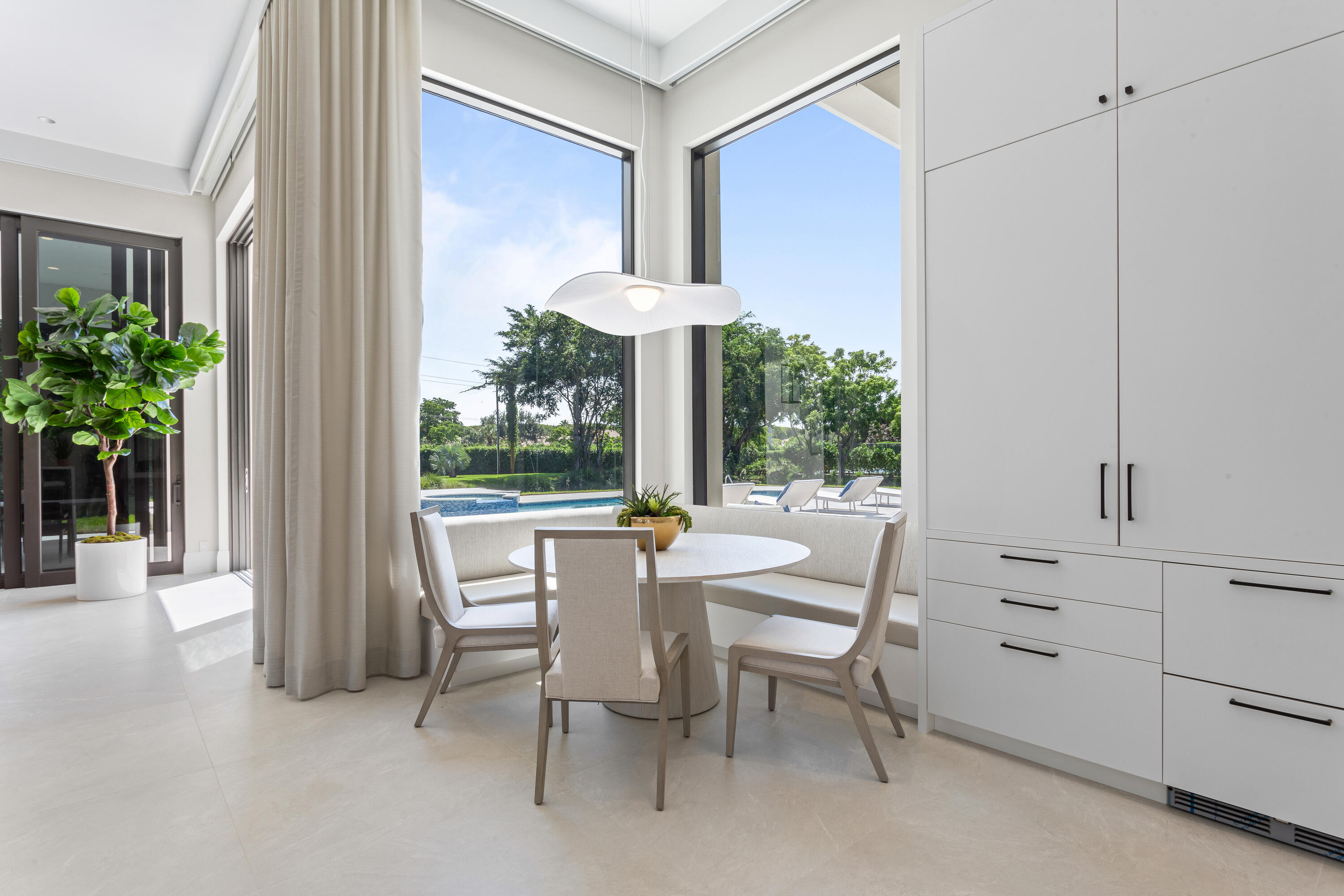 6009 Le Lac Road Boca Raton, FL 33496 - Photo 14 of 35 a dining room with furniture and a potted plant
