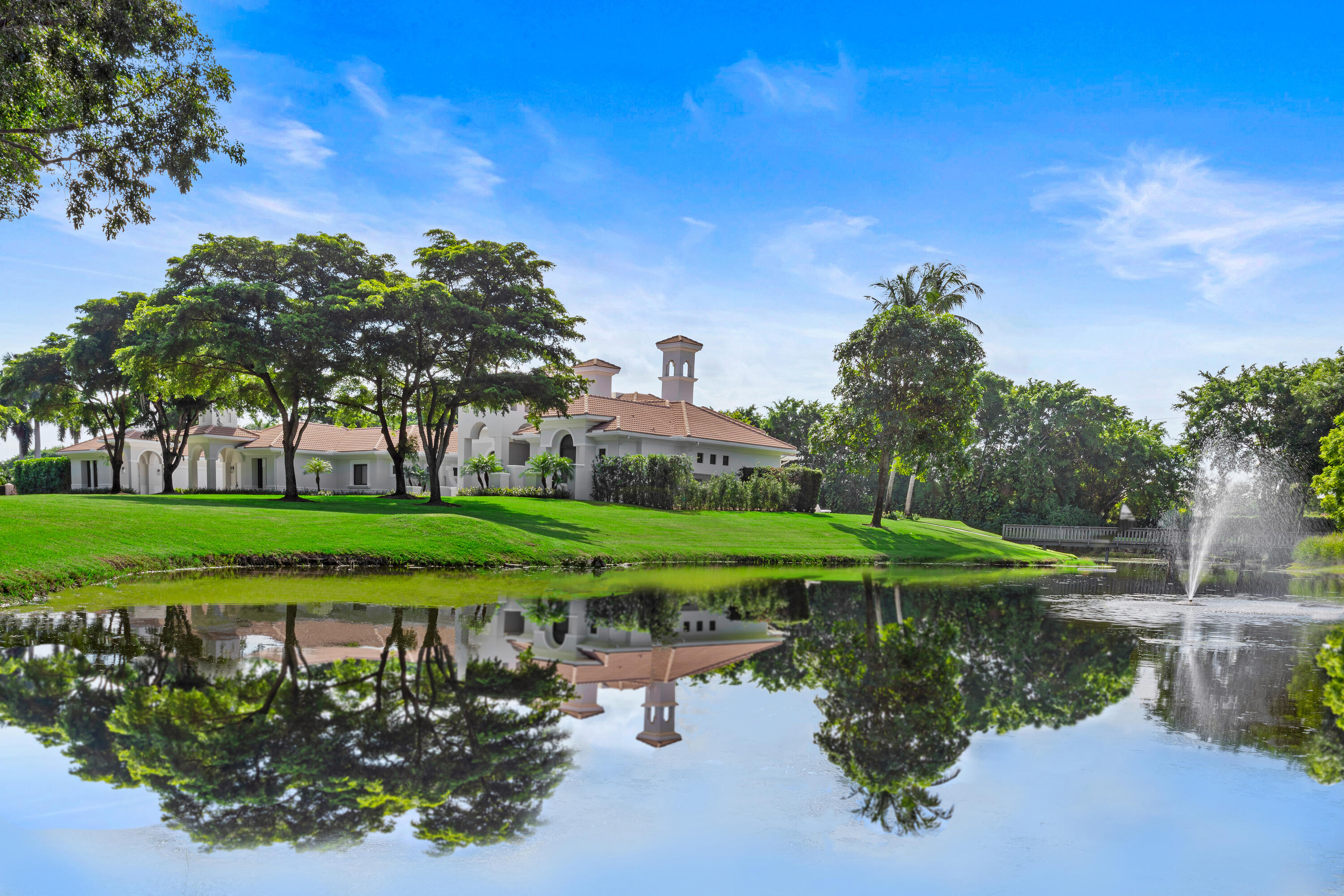 6009 Le Lac Road Boca Raton, FL 33496 - Photo 2 of 35 a view of a lake with a houses in the background