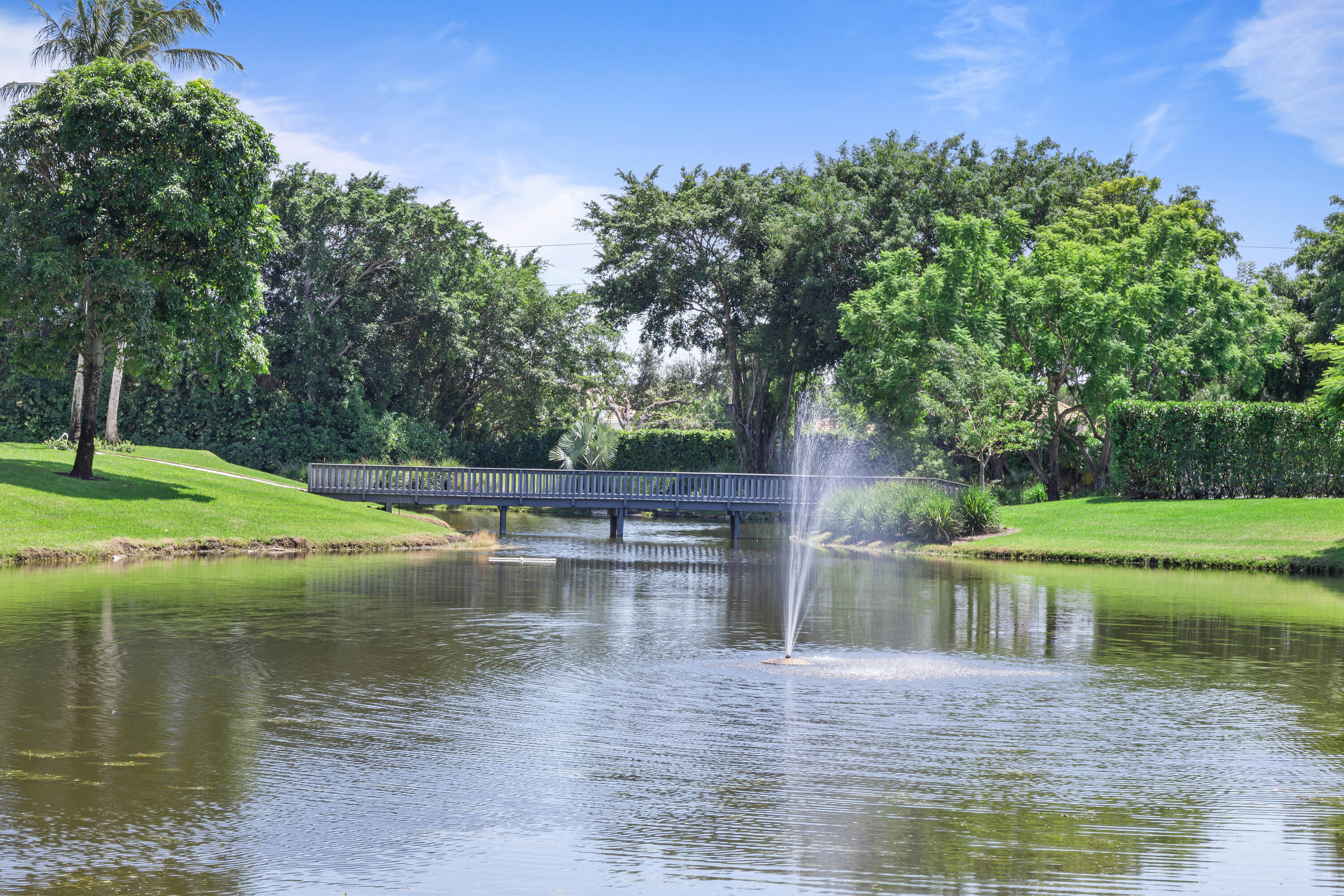 6009 Le Lac Road Boca Raton, FL 33496 - Photo 28 of 35 a view of a lake with a house in the background