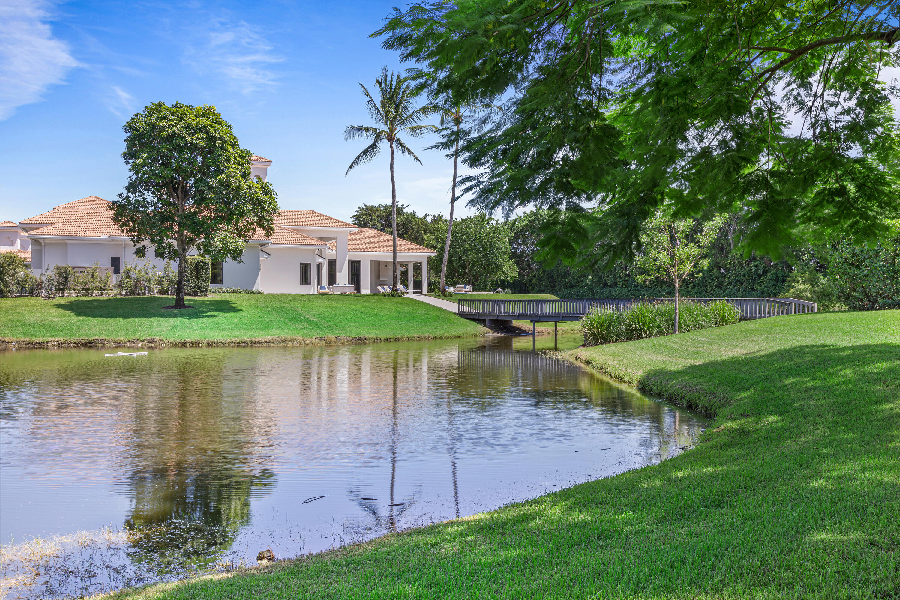 6009 Le Lac Road Boca Raton, FL 33496 - Photo 29 of 35 a view of a house with a yard and a pond