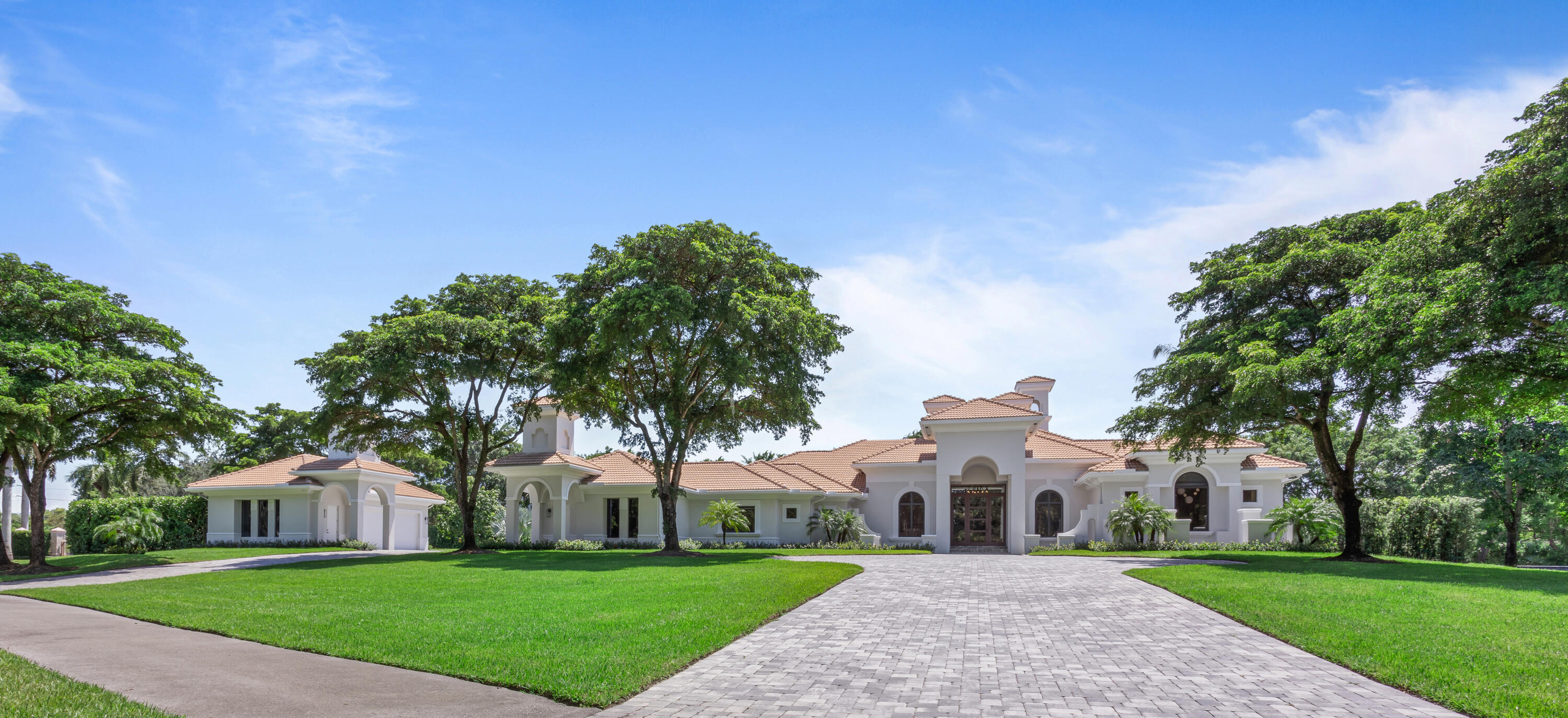 6009 Le Lac Road Boca Raton, FL 33496 - Photo 5 of 35 a front view of a house with a yard and trees