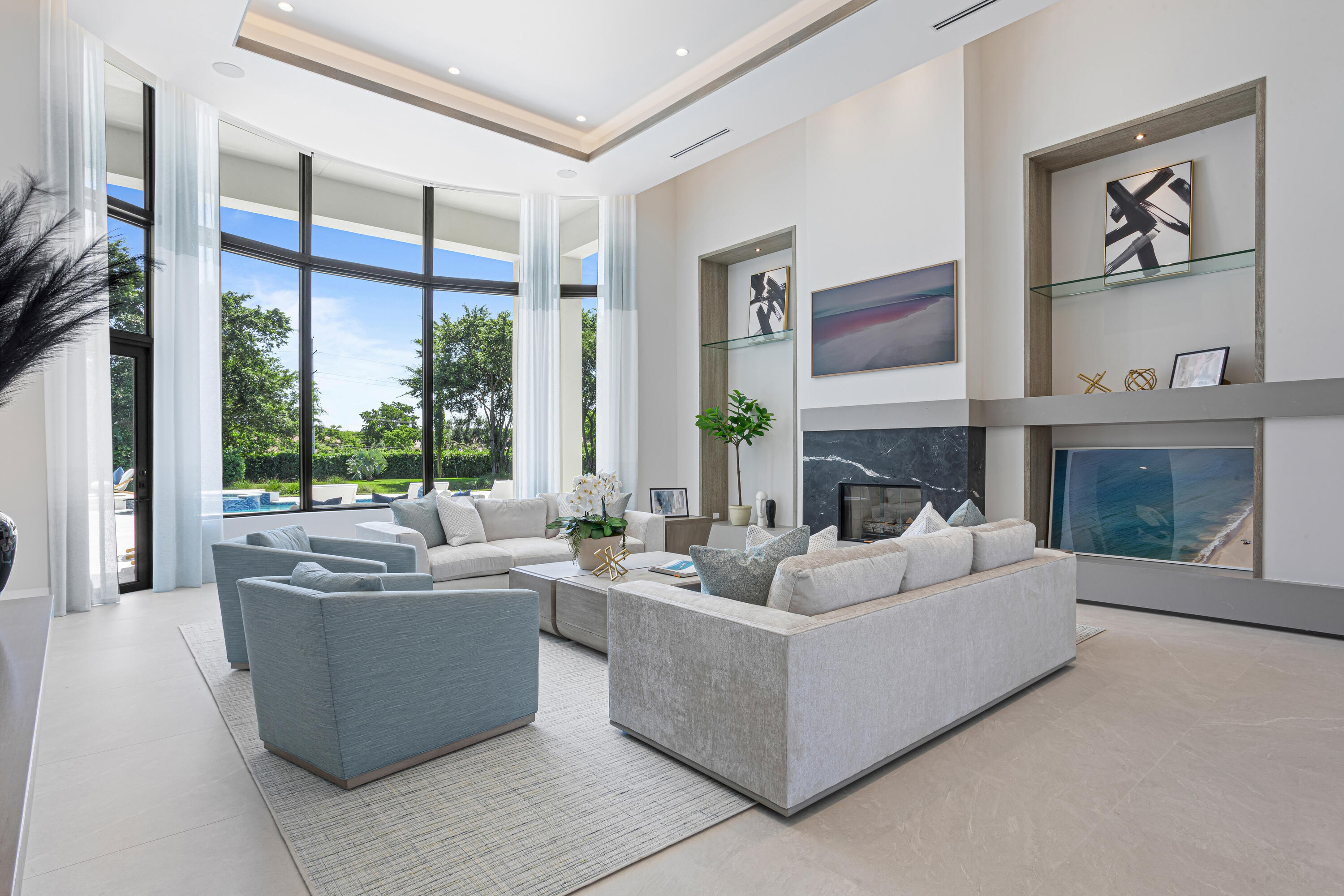 6009 Le Lac Road Boca Raton, FL 33496 - Photo 7 of 35 a living room with furniture a large window and a fireplace