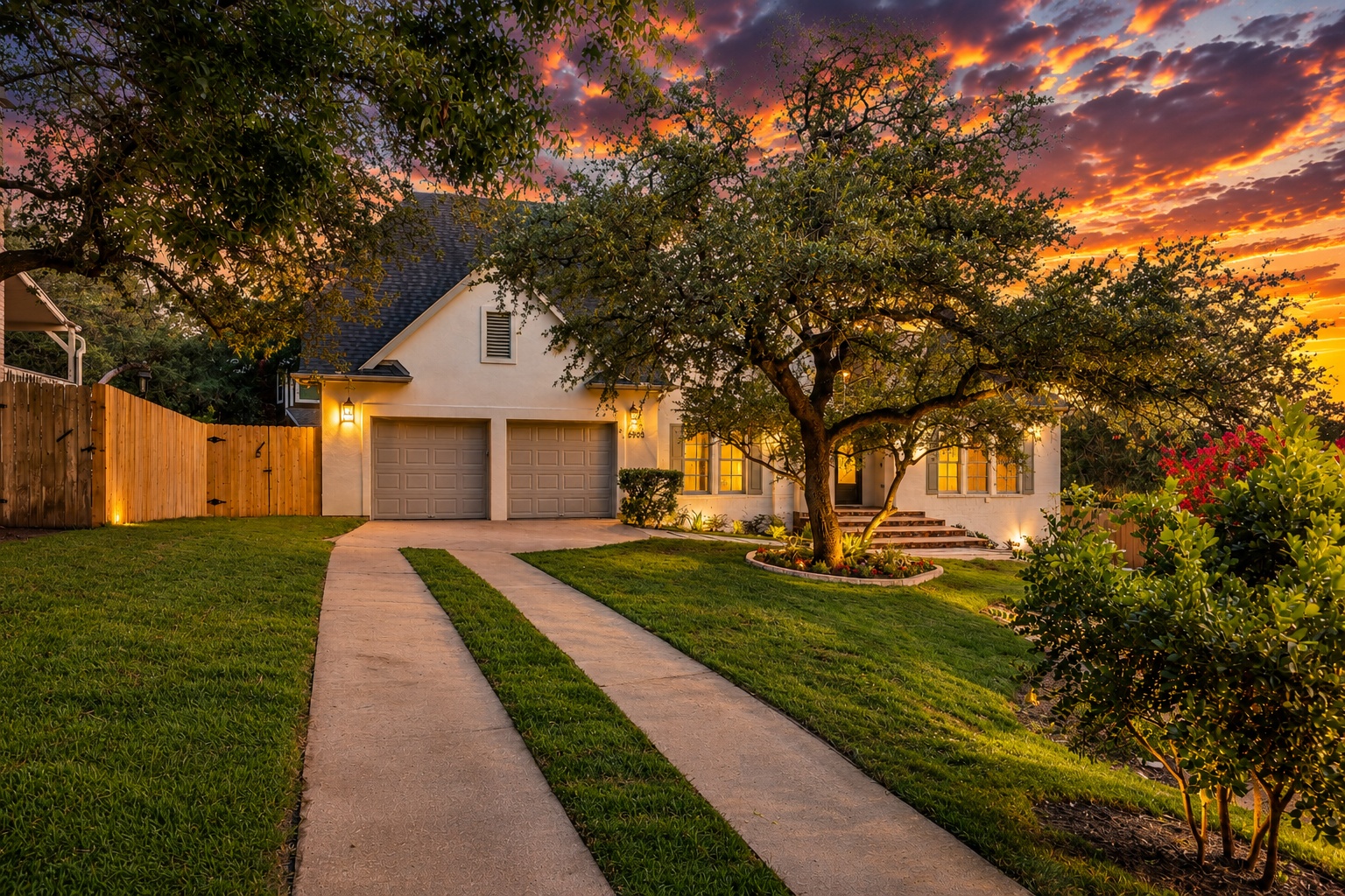 6905 Rudi Cove Austin, TX 78759 - Photo 3 of 37 Twilight paints the sky above a charming home, featuring an inviting driveway and mature landscaping.