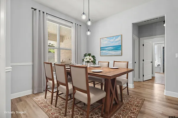 a kitchen with stainless steel appliances granite countertop a sink a stove and a wooden floors