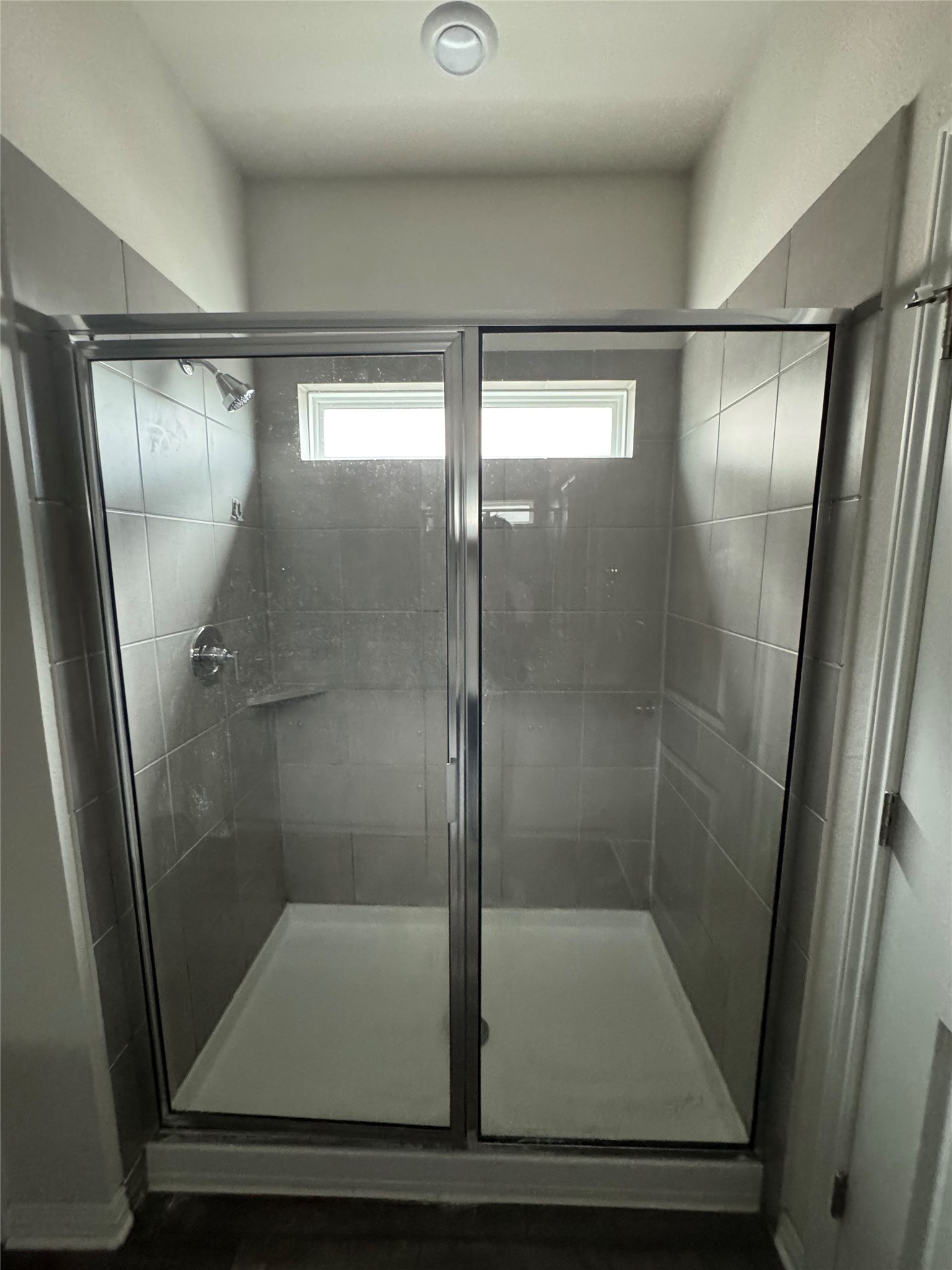 6400 Rounded Pebble Lane Buda, TX 78610 - Photo 19 of 34 a bathroom with a glass shower door