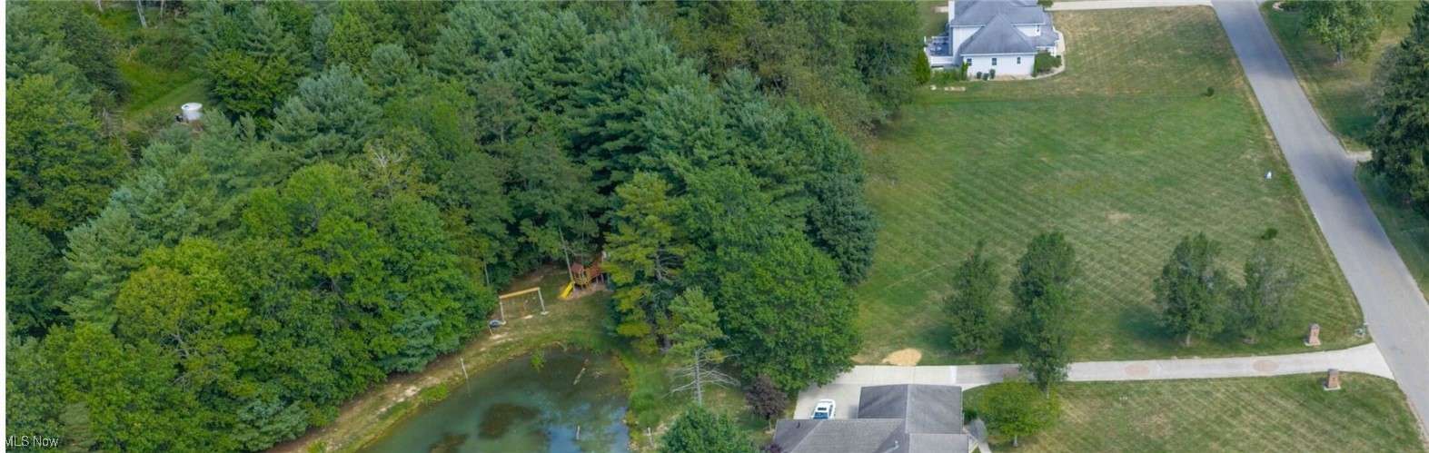 Valley Road Northwest New Philadelphia, OH 44663 - Photo 3 of 3 Aerial view of property and surrounding area featuring a heavily wooded area