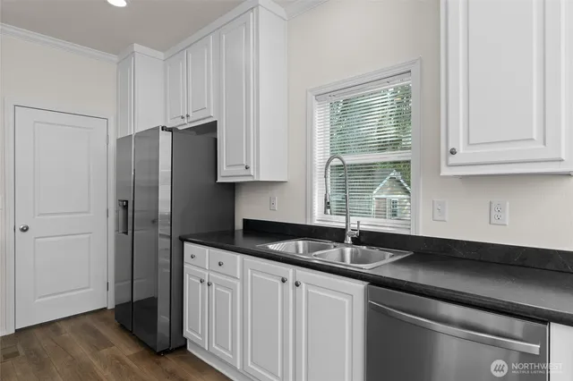 a kitchen with stainless steel appliances granite countertop a sink and a granite counter tops