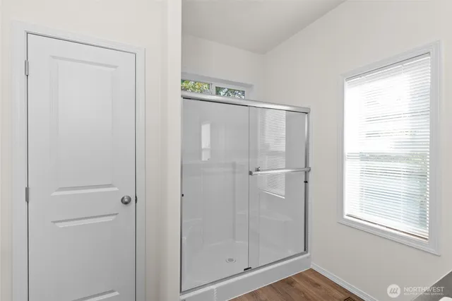 a bathroom with a glass shower door