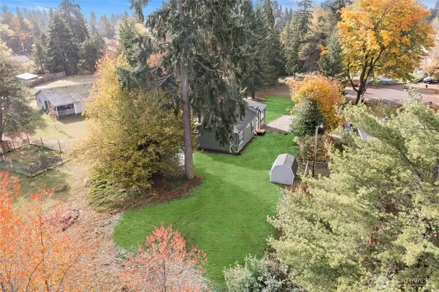 a backyard of a house with a yard and outdoor seating