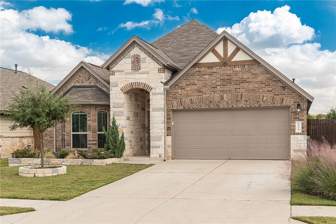 1909 Goldilocks Lane Manchaca, TX 78652 - Photo 1 of 1 a front view of a house with garden