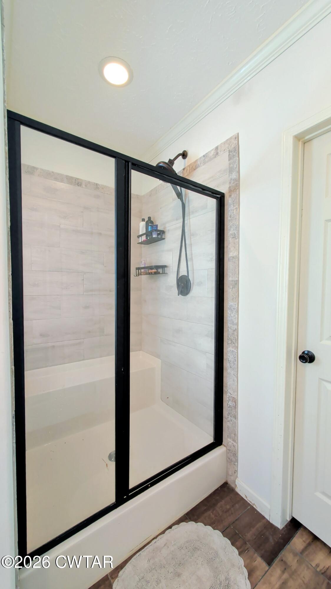 2935 Ed Barham Road Bethel Springs, TN 38315 - Photo 12 of 56 a bathroom with a glass shower door