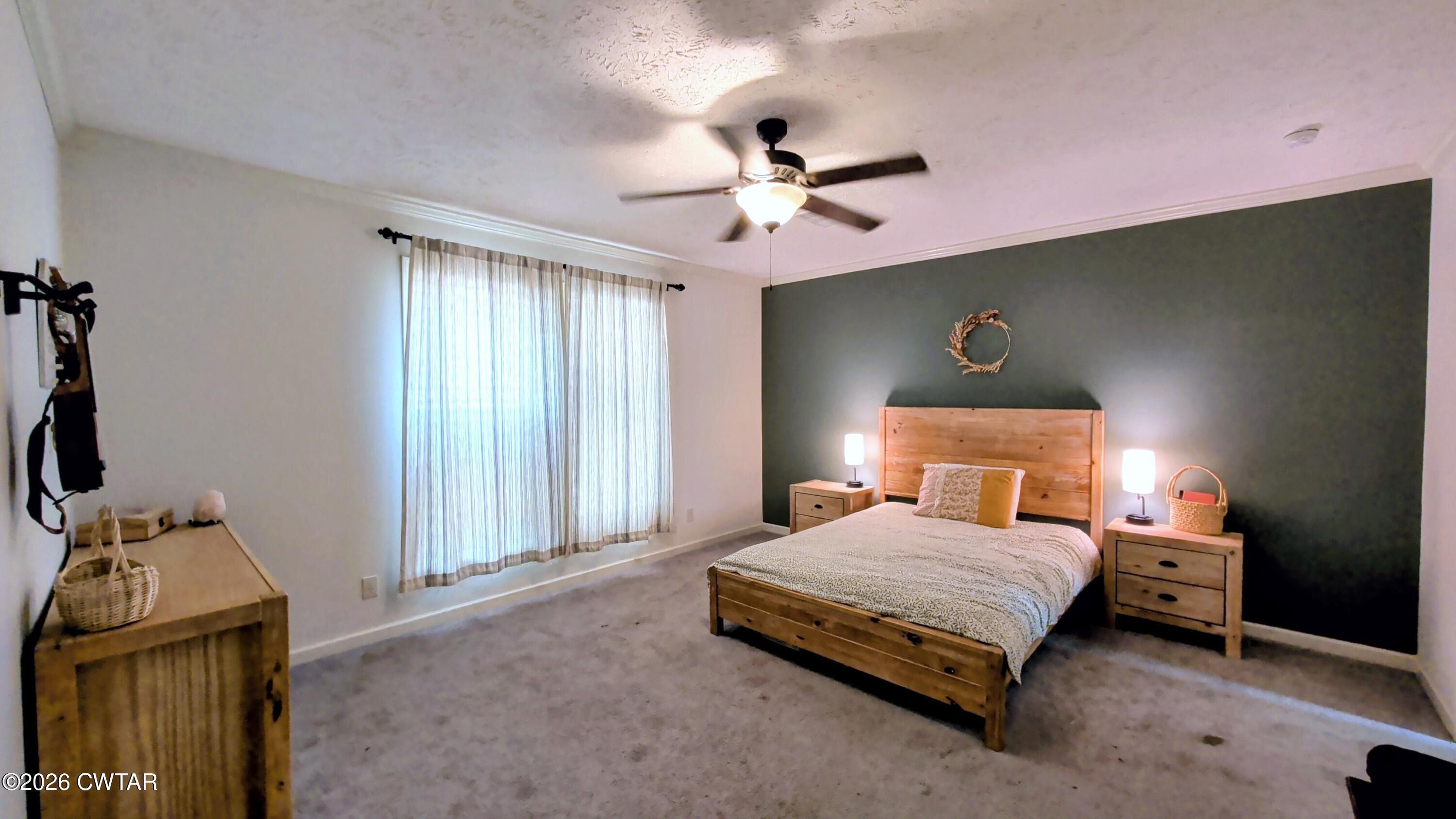 2935 Ed Barham Road Bethel Springs, TN 38315 - Photo 17 of 56 a bedroom with a bed and a flat tv screen on dresser