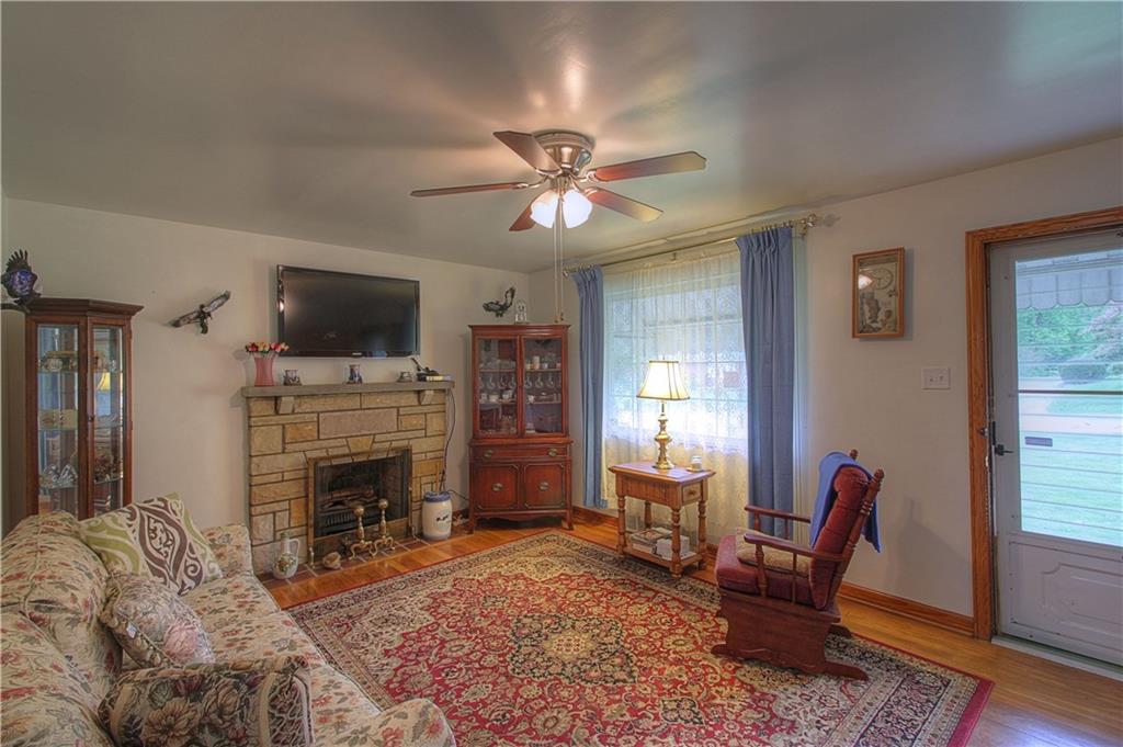 735 Beaver Street Rochester, PA 15074 - Photo 2 of 22 Living Room. Cozy and bright, the living room walls and ceiling are impeccable condition. The textured stone fireplace and mantle complement the solid hardwood floor, doors and trim!