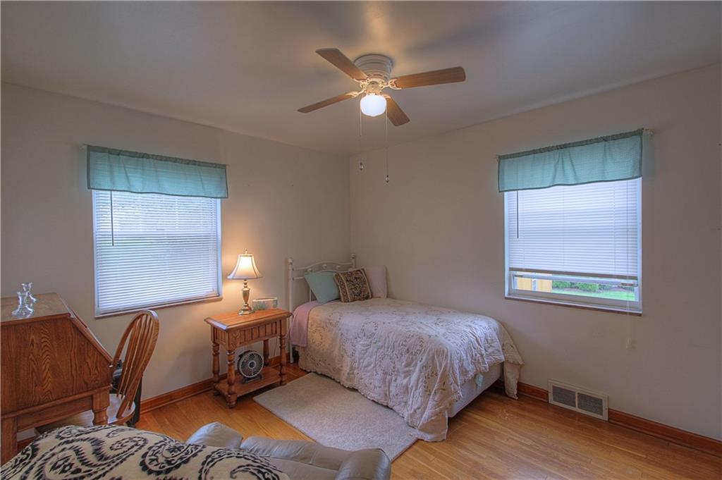 735 Beaver Street Rochester, PA 15074 - Photo 6 of 22 Bedroom 2-First Floor. Original hardwoods, vinyl windows, ceiling fan and burst of sunshine!