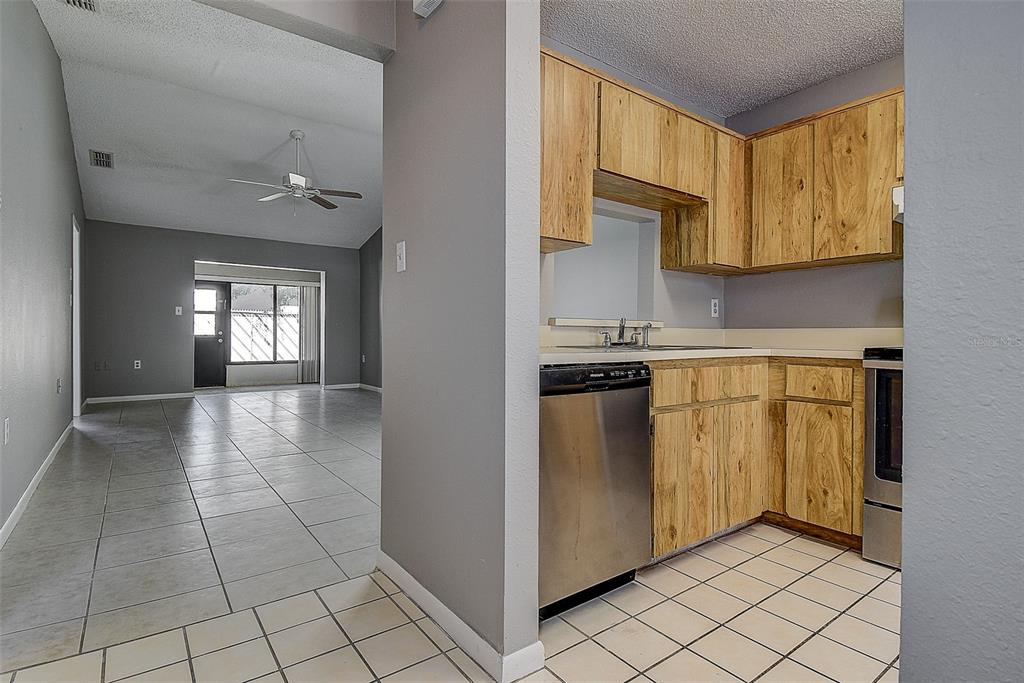 4752 Sunny Loop, Unit 4752 Holiday, FL 34690 - Photo 12 of 28 a view of a kitchen with cabinets