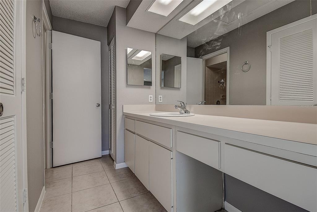 4752 Sunny Loop, Unit 4752 Holiday, FL 34690 - Photo 17 of 28 a bathroom with a sink and a mirror