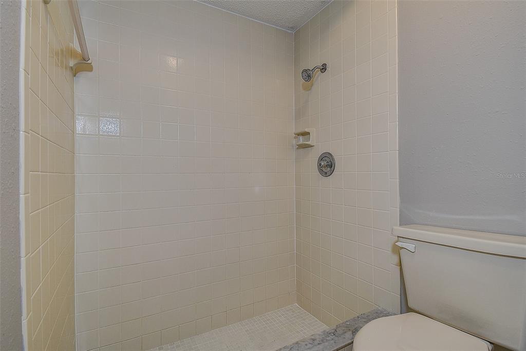 4752 Sunny Loop, Unit 4752 Holiday, FL 34690 - Photo 18 of 28 a bathroom with a toilet and a shower