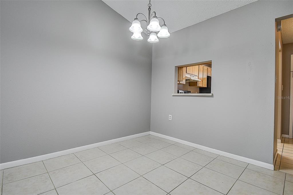 4752 Sunny Loop, Unit 4752 Holiday, FL 34690 - Photo 8 of 28 a view of a chandelier fan and fire place