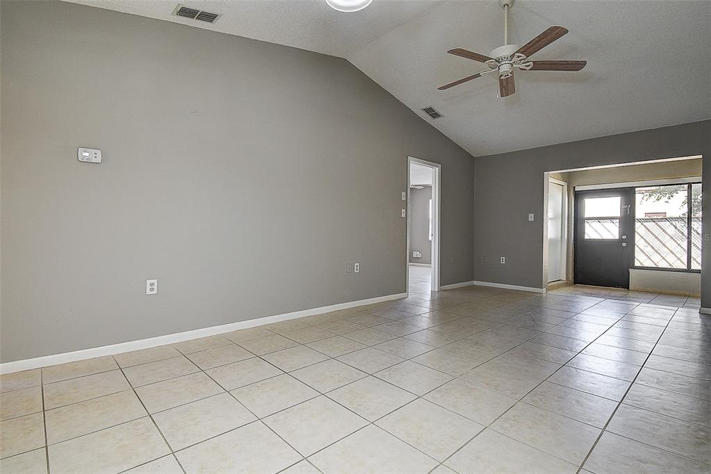 4752 Sunny Loop, Unit 4752 Holiday, FL 34690 - Photo 9 of 28 an empty room with windows and fan