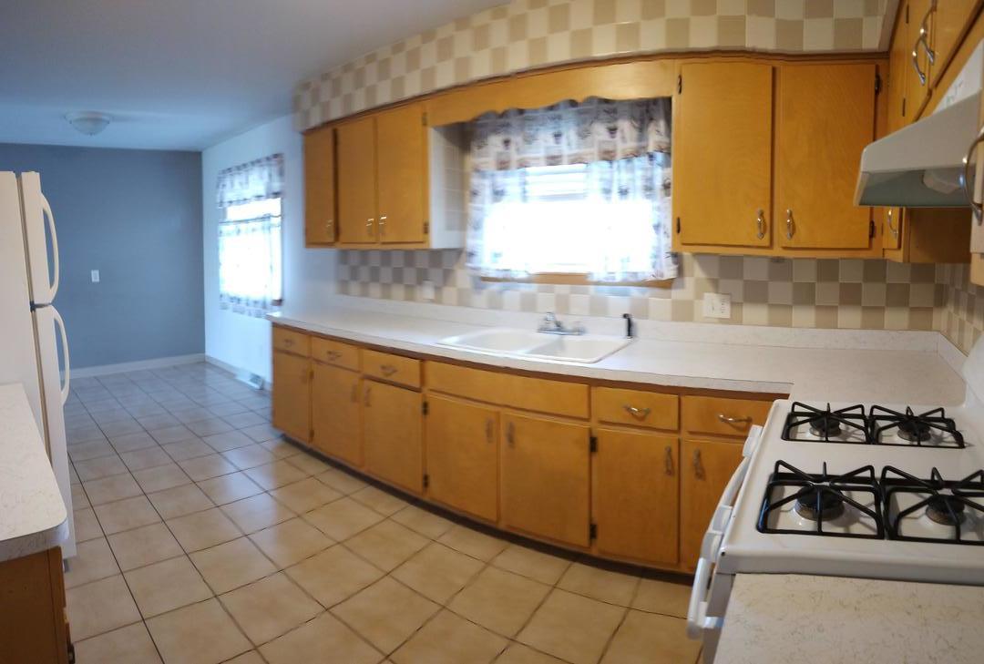 1920 Root Street Crest Hill, IL 60403 - Photo 5 of 17 a kitchen with stainless steel appliances a sink stove and cabinets
