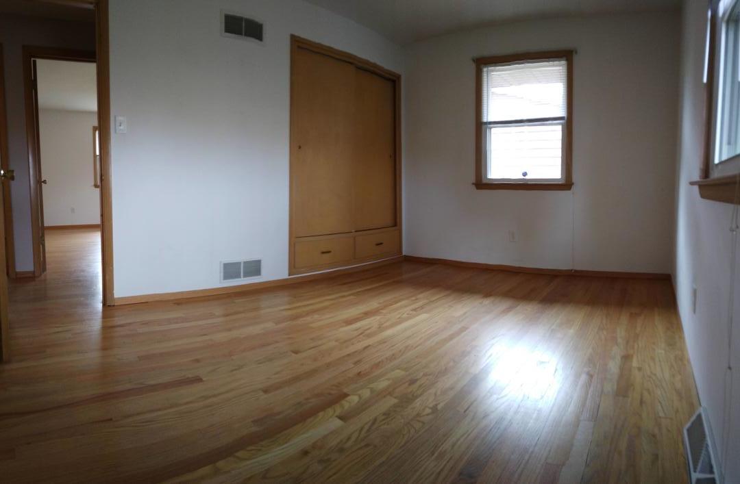 1920 Root Street Crest Hill, IL 60403 - Photo 6 of 17 an empty room with wooden floor and windows