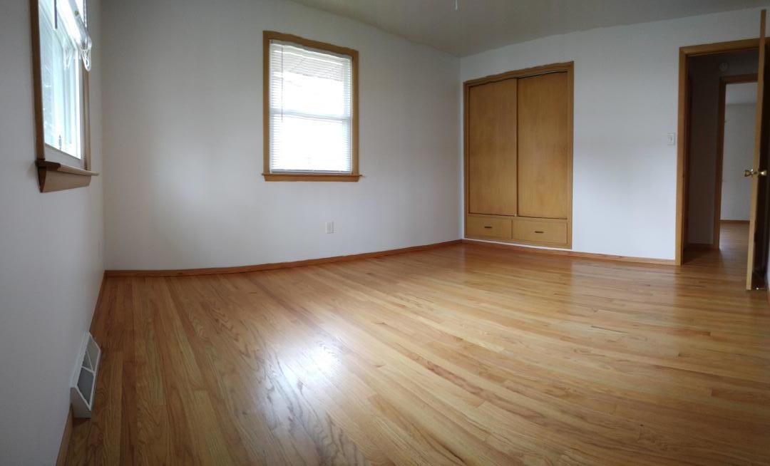 1920 Root Street Crest Hill, IL 60403 - Photo 8 of 17 an empty room with wooden floor and windows