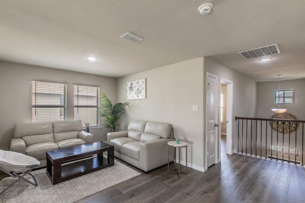 2521 Maidenhair Road Frisco, TX 75033 - Photo 17 of 39 Spacious living area featuring wood-finish flooring, recessed lighting, and ample natural light from two windows