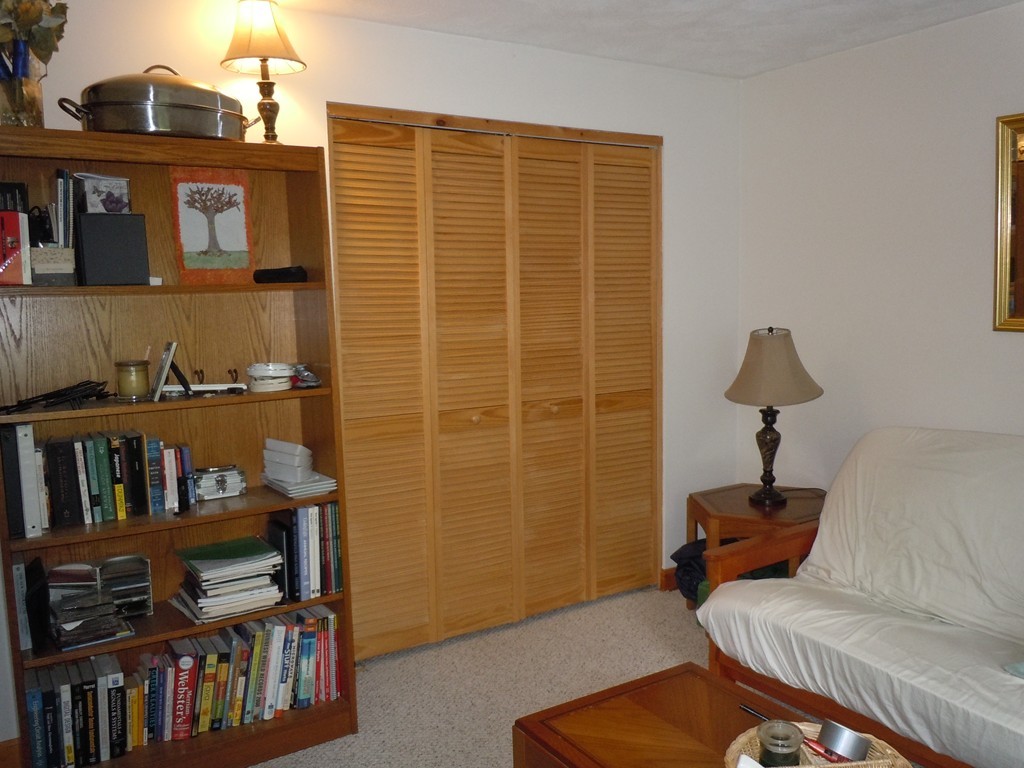 209 Great Road, Unit C9 Acton, MA 01720 - Photo 8 of 15 a living room with furniture and a book shelf