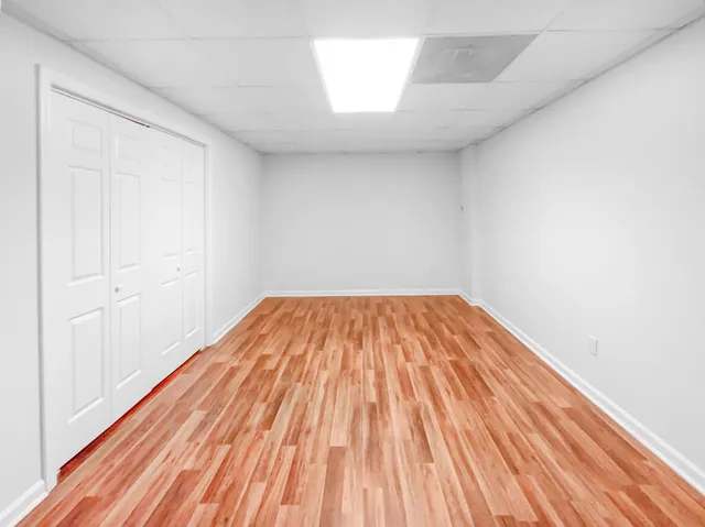 a view of a room with wooden floor