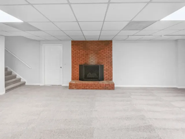 a view of an empty room with a fireplace