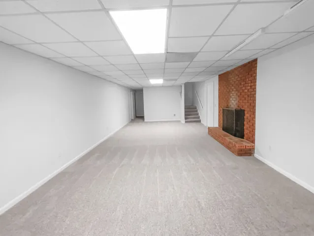 a view of a livingroom with an empty space and a fireplace