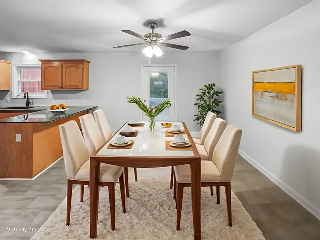 a view of a dining room with furniture and a potted plant